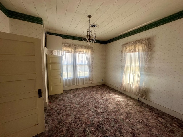 unfurnished dining area with wood ceiling, crown molding, a chandelier, and carpet flooring