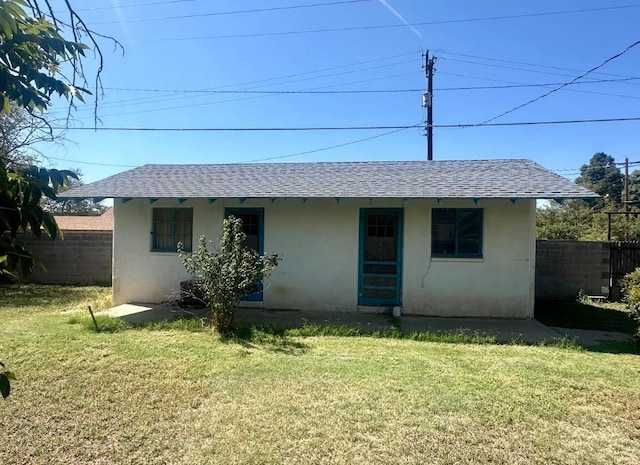 back of property featuring a lawn