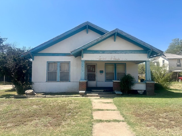 view of front of house featuring a front yard and a porch