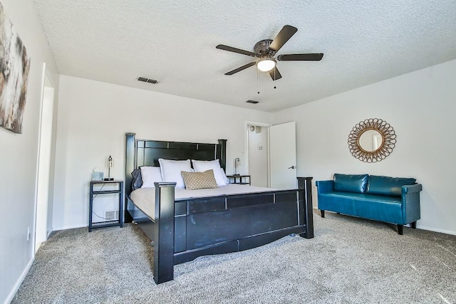 carpeted bedroom featuring ceiling fan and a textured ceiling