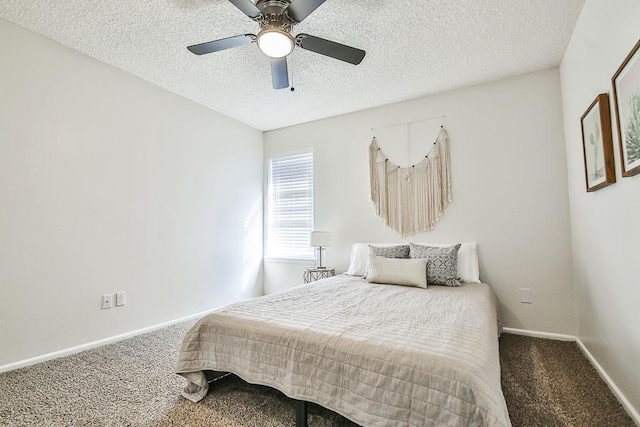 carpeted bedroom with ceiling fan and a textured ceiling