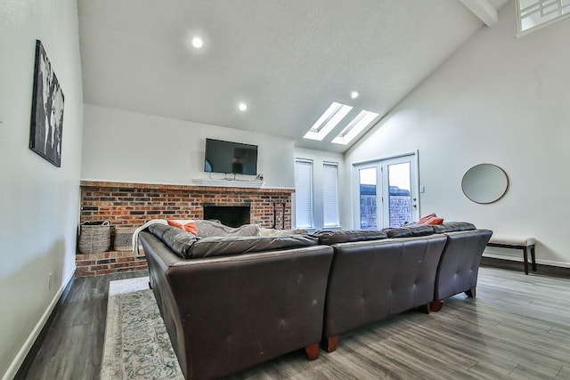 living room with hardwood / wood-style flooring, a fireplace, and high vaulted ceiling