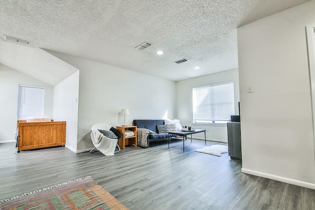 living area featuring hardwood / wood-style flooring and a textured ceiling