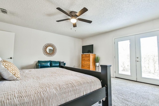 carpeted bedroom with french doors, ceiling fan, access to exterior, and a textured ceiling