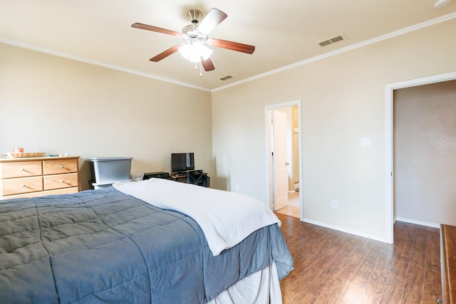 bedroom with ornamental molding, dark hardwood / wood-style floors, and ceiling fan