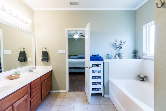 bathroom with vanity, a bath, ornamental molding, and tile patterned floors