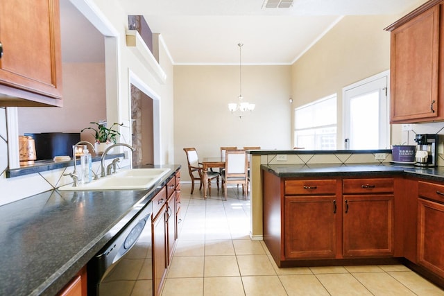 kitchen with light tile patterned flooring, dishwasher, sink, hanging light fixtures, and a notable chandelier