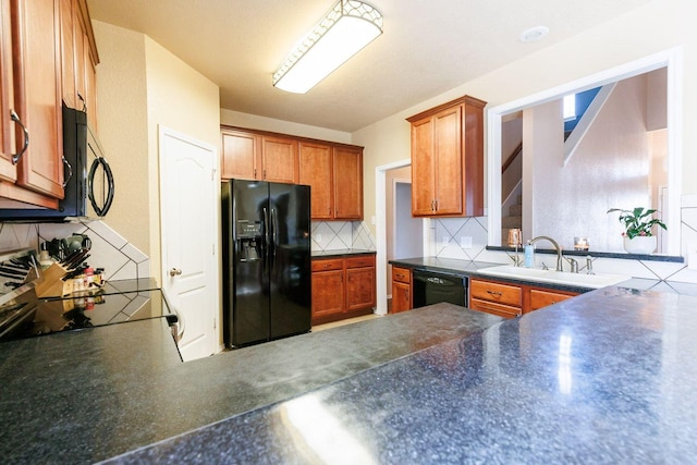 kitchen featuring tasteful backsplash, sink, and black appliances