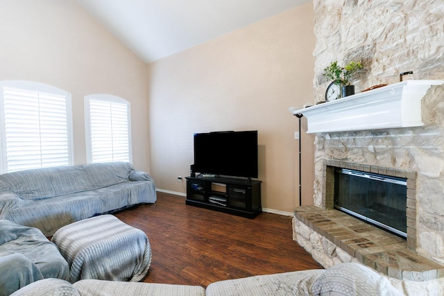 living room with a stone fireplace, high vaulted ceiling, and dark hardwood / wood-style flooring