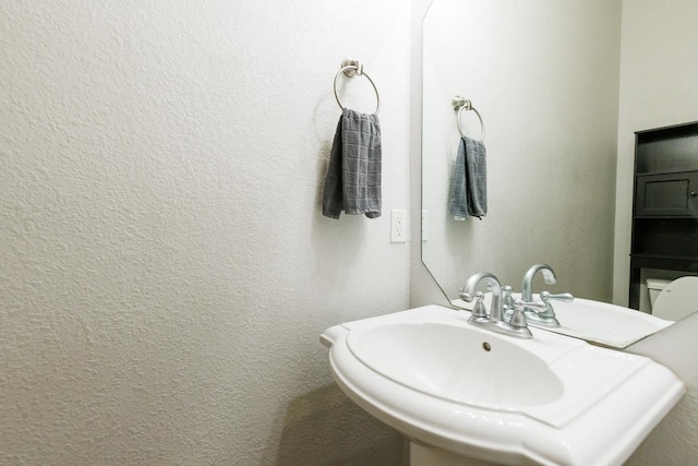 bathroom featuring sink and toilet