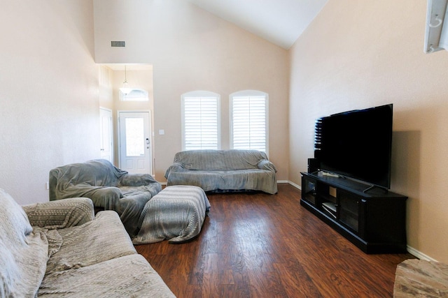 living room featuring dark hardwood / wood-style floors and high vaulted ceiling