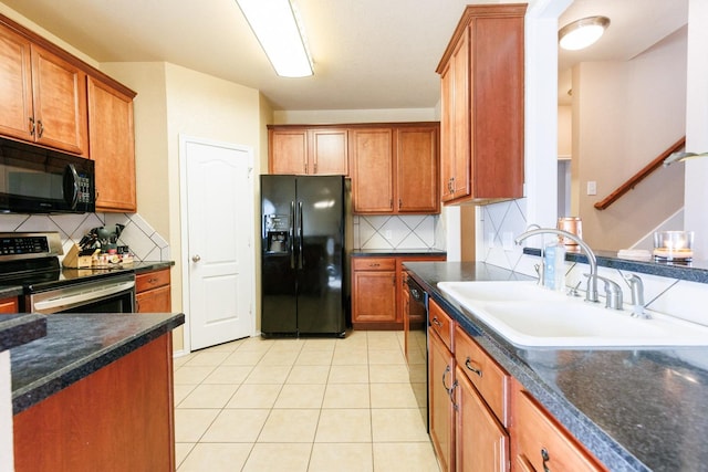 kitchen featuring sink, light tile patterned floors, backsplash, and black appliances