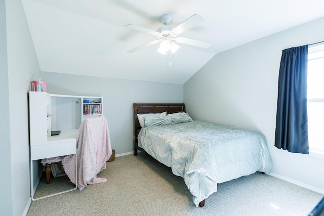 carpeted bedroom featuring ceiling fan and vaulted ceiling