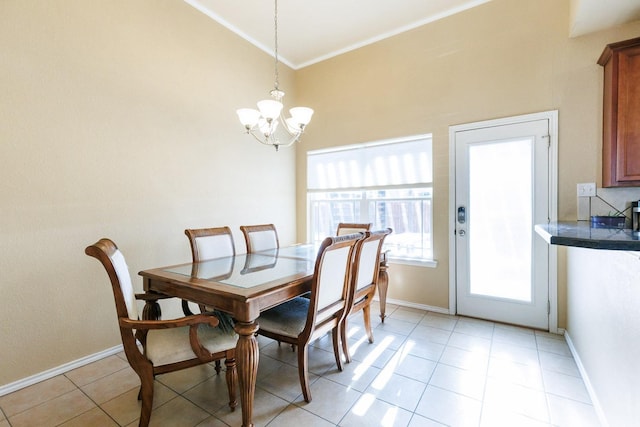 tiled dining room featuring an inviting chandelier and ornamental molding