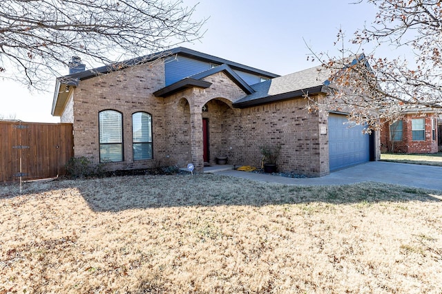 view of front of property featuring a garage and a front lawn