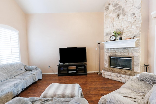 living room with a fireplace and dark hardwood / wood-style flooring