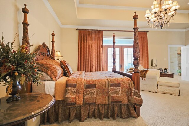 bedroom with crown molding, a tray ceiling, carpet flooring, and a chandelier