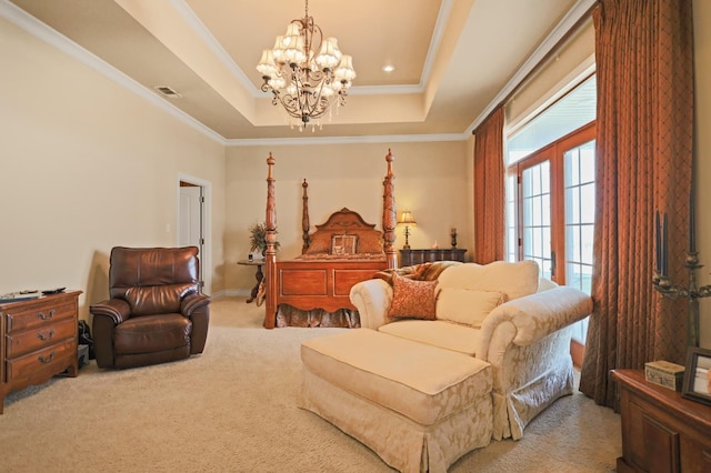 bedroom featuring crown molding, a tray ceiling, a chandelier, and carpet floors