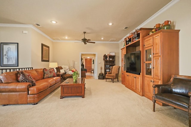 carpeted living room with ornamental molding and ceiling fan