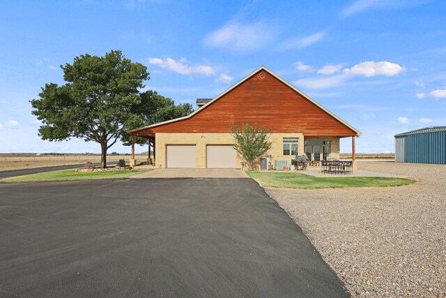 view of front of property with a garage and central AC unit