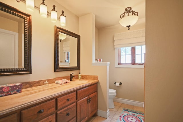 bathroom featuring tile patterned flooring, vanity, and toilet