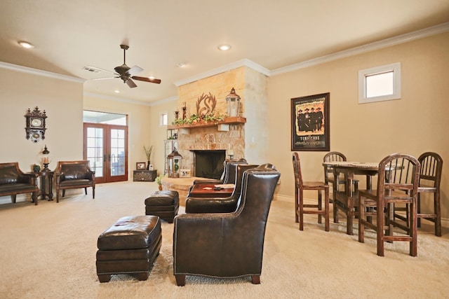 living room with ornamental molding, a fireplace, light colored carpet, and french doors