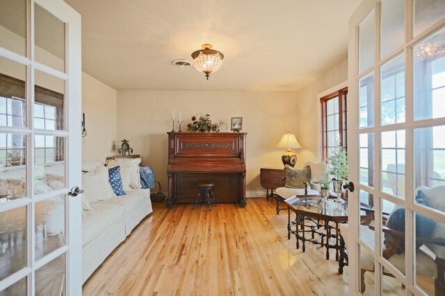 sitting room with light wood-type flooring and french doors