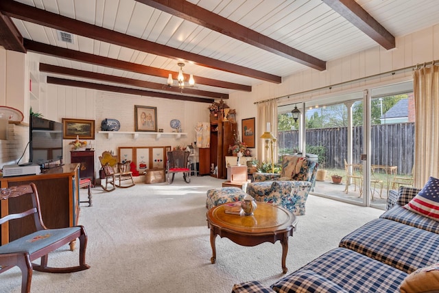 living room featuring beam ceiling, light colored carpet, and a chandelier