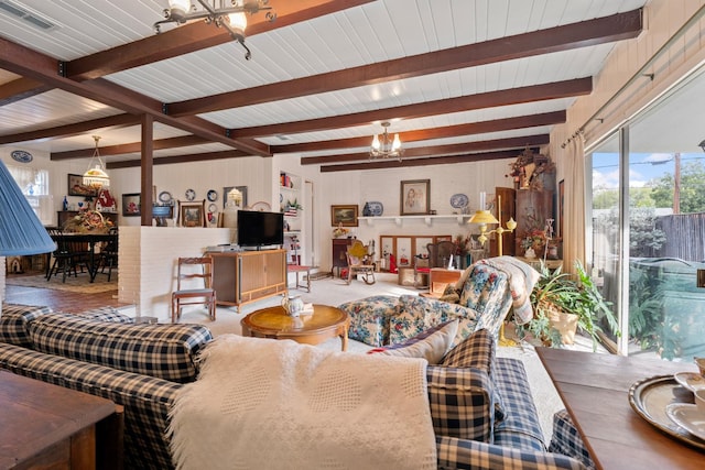 living room with beam ceiling and a chandelier