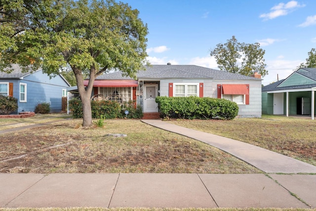 ranch-style home with a front lawn