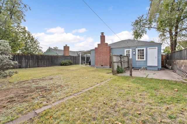 back of house with a yard and a patio