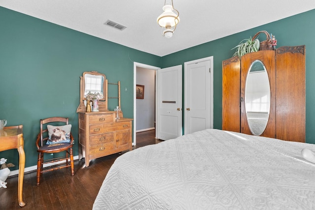 bedroom with dark hardwood / wood-style flooring