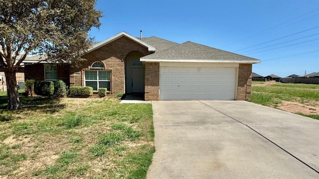 ranch-style home with a garage and a front lawn