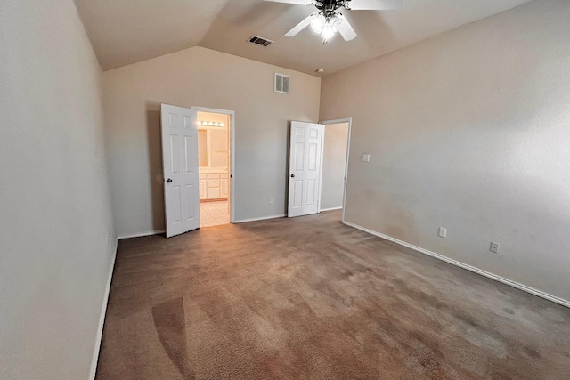 unfurnished bedroom with high vaulted ceiling, ensuite bathroom, ceiling fan, and carpet