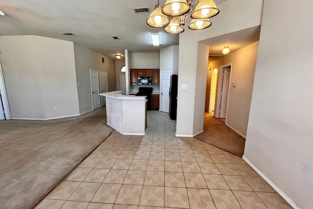 kitchen featuring an inviting chandelier, a center island, vaulted ceiling, light colored carpet, and black appliances