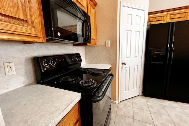 kitchen with light tile patterned floors and black appliances