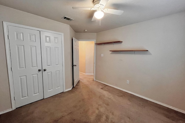 unfurnished bedroom with light carpet, a closet, and ceiling fan