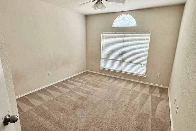 spare room featuring carpet floors and ceiling fan