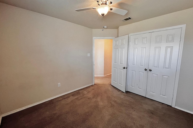 unfurnished bedroom featuring carpet, ceiling fan, and a closet