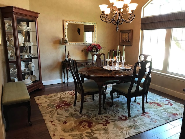 3909 101st St, Lubbock, TX 79423 - dining area with baseboards, a notable chandelier, a healthy amount of sunlight, and wood finished floors