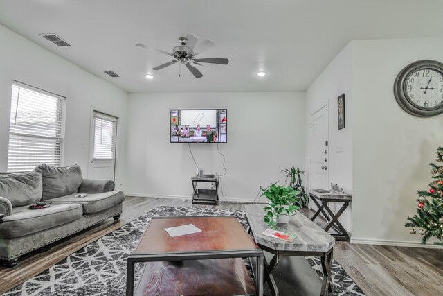 living room with hardwood / wood-style flooring and ceiling fan