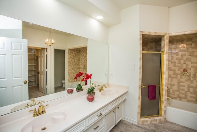 full bathroom featuring vanity, toilet, separate shower and tub, and a notable chandelier