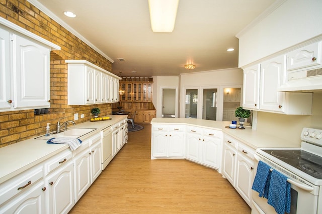 kitchen with white appliances, kitchen peninsula, and white cabinets