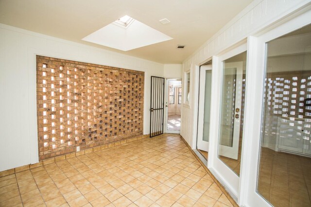 spare room with a skylight