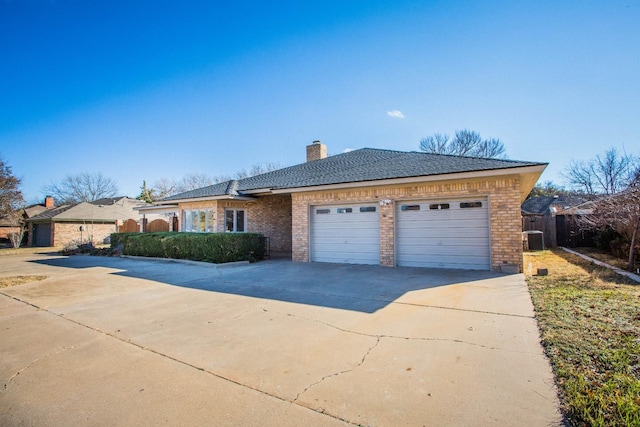 ranch-style house with a garage and central AC