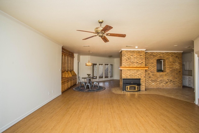 unfurnished living room with hardwood / wood-style flooring, ceiling fan, and crown molding