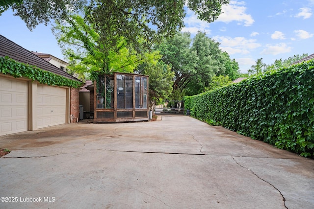 5118 2nd St, Lubbock, TX 79416 - view of patio / terrace with concrete driveway and a garage