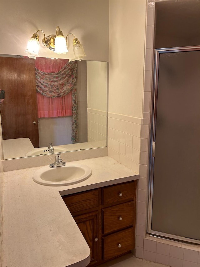 bathroom featuring an enclosed shower and vanity