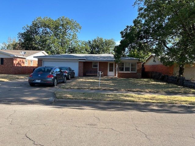 single story home with a garage and a front yard