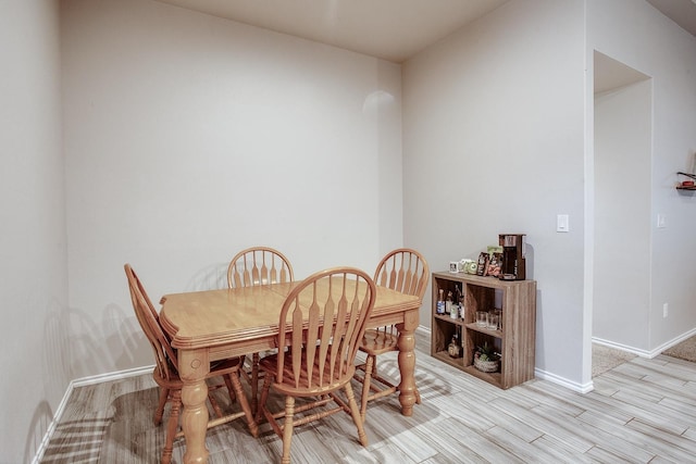 dining space with light hardwood / wood-style flooring